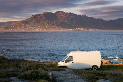 Scenic view of sea and mountains against sky