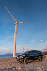 Windmill on field against sky