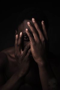 Cropped image of hand looking up over black background