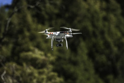 Close-up of drone flying against sky