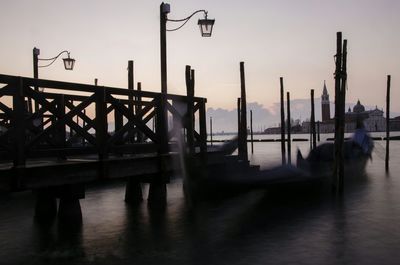 Gondola in grand canal against sky at dusk