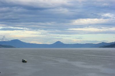 Scenic view of mountains against cloudy sky