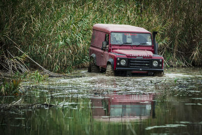 Vintage car on grass by water