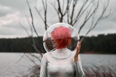 Portrait of woman in lake against trees