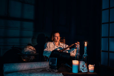 Full length of man sitting on table