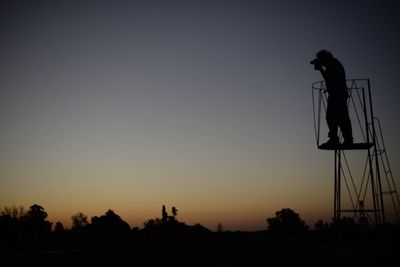 Low angle view of silhouette trees against clear sky