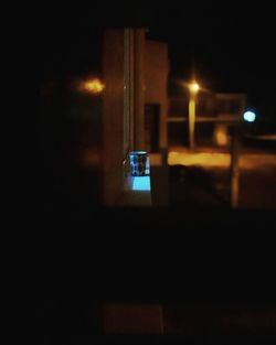 Reflection of illuminated car on street at night