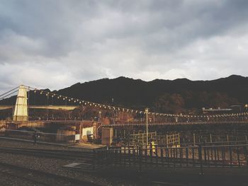 Railroad tracks by mountains against sky