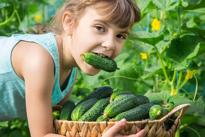 Portrait of young woman holding plant