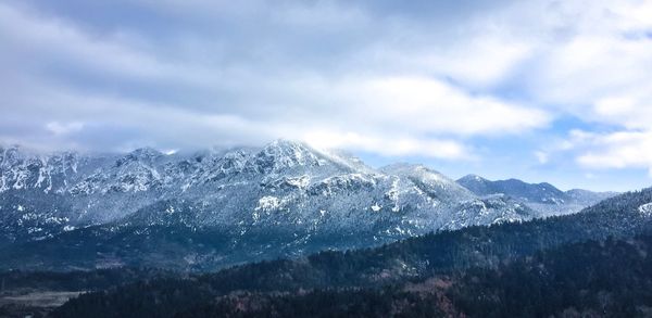 Scenic view of snowcapped mountains against sky