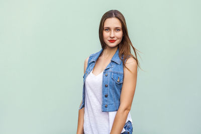 Portrait of beautiful young woman over white background