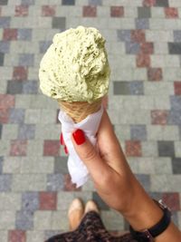 Close-up of woman holding ice cream cone