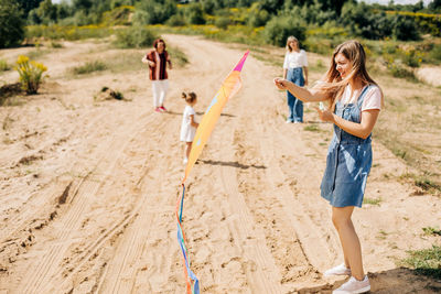 Several generations of women of the same family fly a kite during a joint holiday