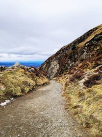 Road by sea against sky