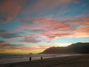 Scenic view of beach against sky during sunset