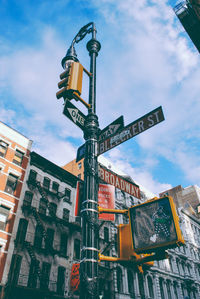 Low angle view of stoplight against buildings in city