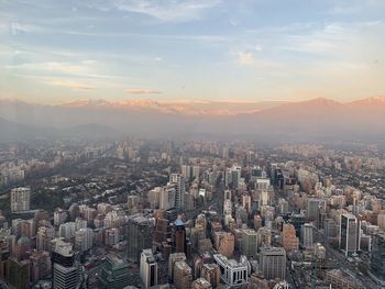 High angle view of modern buildings against sky during sunset