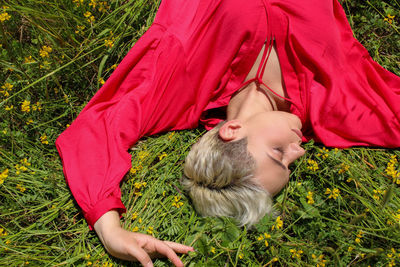 High angle view of woman lying on field