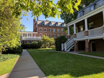 Lawn by house against sky