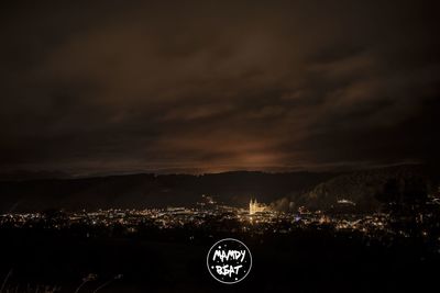 Illuminated city against sky at night