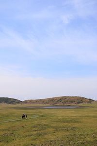 Man on field against sky