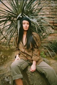 Portrait of young woman sitting outdoors