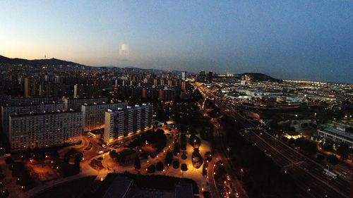 High angle view of illuminated city buildings at night