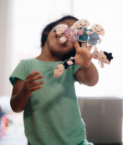 Close-up of cute girl holding toy at home