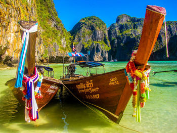 Panoramic view of boats moored on sea against mountains