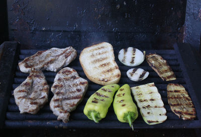 Vegetables and meat on grill