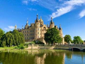 Castle by lake against sky