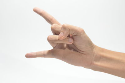 Close-up of human hand against white background