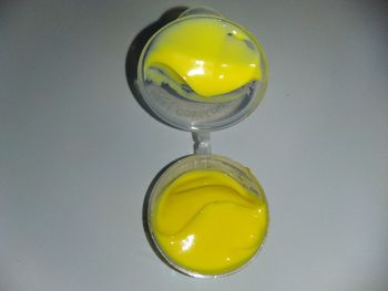 Close-up of yellow glass over white background