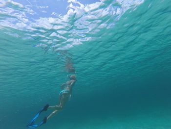 Low angle view of woman snorkeling undersea