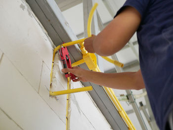 Midsection of man working in workshop