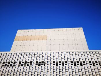 Low angle view of building against clear blue sky