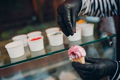 Person holding pink ice cream cone