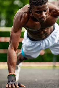 Low section of man exercising on road