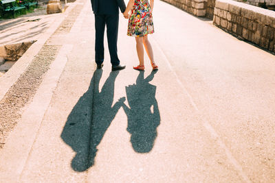 Low section of people walking on street