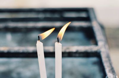 Close-up of burning candles on temple