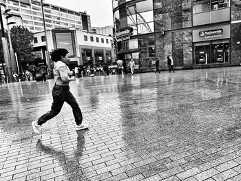 Man running on street in city