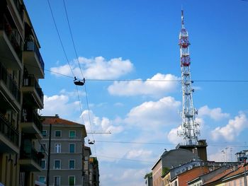 Low angle view of communications tower against sky