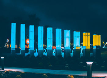 Illuminated buildings against sky at night