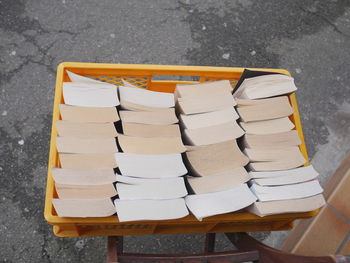 High angle view of books in crate on footpath