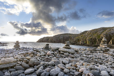 Rocks on beach against sky