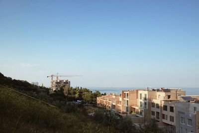 Buildings in city against clear sky
