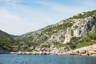 Scenic view of sea and buildings against sky