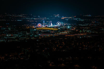 High angle view of illuminated city against sky at night