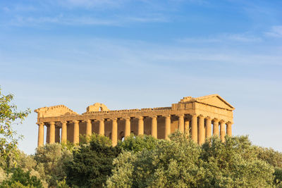 Low angle view of historical building against blue sky
