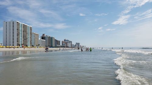 Scenic view of sea and buildings against sky